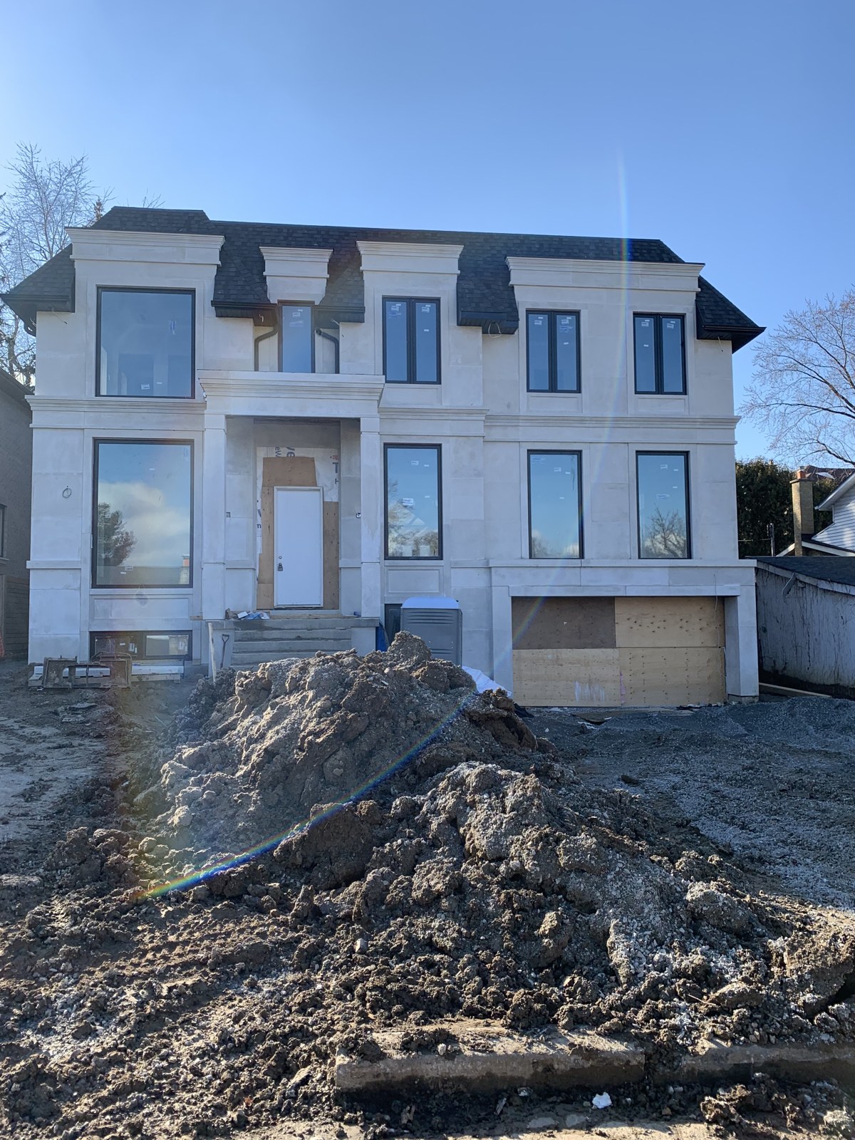 Custom stone-clad home, exterior nearing completion